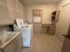 Bright laundry room featuring cabinetry, sink, washer, and dryer at 6912 10Th W Ave, Bradenton, FL 34209