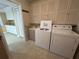 Clean laundry room featuring lots of cabinetry, a utility sink, washer, and dryer at 6912 10Th W Ave, Bradenton, FL 34209