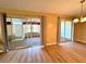 Bright living area featuring new flooring and sliding glass doors leading to enclosed lanai at 6912 10Th W Ave, Bradenton, FL 34209