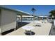Community pool area with ample seating and shade from palm trees and umbrellas at 6912 10Th W Ave, Bradenton, FL 34209