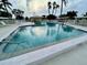 Exterior shot of a community pool surrounded by lounge chairs and palm trees at 6912 10Th W Ave, Bradenton, FL 34209