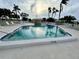 Community pool surrounded by palm trees, lounge chairs, and lush landscaping at 6912 10Th W Ave, Bradenton, FL 34209