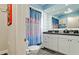 Bathroom featuring dual sinks, granite counters, and a shower with curtain at 7019 10Th S St, St Petersburg, FL 33705