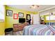 Bedroom with ceiling fan, mirror doors, and yellow-painted walls at 7019 10Th S St, St Petersburg, FL 33705