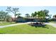 A charming single-Gathering home with a well-manicured lawn and mature palm trees in Florida at 7019 10Th S St, St Petersburg, FL 33705
