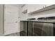 Laundry room featuring modern appliances and white cabinets at 7019 10Th S St, St Petersburg, FL 33705