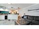 Open living room featuring a gray sofa, ottoman, and a kitchen at 7019 10Th S St, St Petersburg, FL 33705