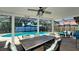 Spacious screened-in pool area with large dining table and comfortable seating at 7019 10Th S St, St Petersburg, FL 33705