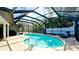 Enclosed pool with deck and lounge chair at 7019 10Th S St, St Petersburg, FL 33705