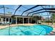 Inviting pool area with a covered patio, complete with comfortable seating and outdoor dining at 7019 10Th S St, St Petersburg, FL 33705