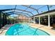 Enclosed pool with brick paver deck and outdoor dining area at 7019 10Th S St, St Petersburg, FL 33705