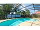 Screened-in pool with a brick deck and a view of the backyard at 7019 10Th S St, St Petersburg, FL 33705