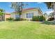 Lush backyard with manicured lawn and mature trees surrounding the residence, offering privacy at 7270 Alicante Dr # 3, Sarasota, FL 34238