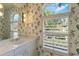 Well-lit bathroom with a bright window view and a modern white vanity, providing a refreshing atmosphere at 7270 Alicante Dr # 3, Sarasota, FL 34238