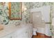 Charming bathroom features a tub with floral wallpaper, enhancing a tranquil and inviting ambiance at 7270 Alicante Dr # 3, Sarasota, FL 34238