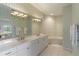 Elegant bathroom featuring a double sink vanity and a soaking tub for a luxurious experience at 7270 Alicante Dr # 3, Sarasota, FL 34238