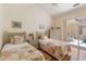 Cozy bedroom featuring two twin beds, warm lighting, and sliding glass door leading to the pool at 7270 Alicante Dr # 3, Sarasota, FL 34238