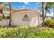 Beautiful Valencia community entrance with lush tropical landscaping and a modern, welcoming design at 7270 Alicante Dr # 3, Sarasota, FL 34238