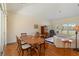 Dining room with hardwood floors, a wood table, and sliding glass doors to the outdoor area at 7270 Alicante Dr # 3, Sarasota, FL 34238