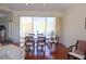 Dining area with wood floors, an elegant table, and a view of the enclosed pool and patio area at 7270 Alicante Dr # 3, Sarasota, FL 34238