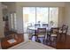 Bright dining room boasts hardwood floors and a large window with a view of the outdoor pool area at 7270 Alicante Dr # 3, Sarasota, FL 34238