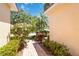 Charming home entrance with a brick path and lush landscaping, creating a welcoming curb appeal at 7270 Alicante Dr # 3, Sarasota, FL 34238