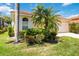 Attractive home featuring a well-maintained lawn, mature landscaping, and a charming arched window at 7270 Alicante Dr # 3, Sarasota, FL 34238