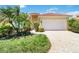 Inviting single-Gathering home featuring a light yellow exterior, a red tile roof, and a paver driveway and walkway at 7270 Alicante Dr # 3, Sarasota, FL 34238