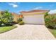 Inviting home exterior with a wide driveway, showcasing curb appeal and a well-maintained landscape at 7270 Alicante Dr # 3, Sarasota, FL 34238