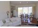 Comfortable living room with large sliding glass doors to the outside, wood floors, and plenty of seating at 7270 Alicante Dr # 3, Sarasota, FL 34238