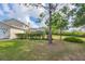 A beautifully landscaped backyard with lush greenery and a screened-in lanai at 8015 Panther Ridge Trl, Bradenton, FL 34202