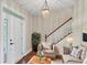 Inviting living room featuring neutral furniture, hardwood floors, staircase, and front door at 8015 Panther Ridge Trl, Bradenton, FL 34202