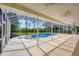 A sparkling pool is encased within a screened enclosure and surrounded by mature trees at 8015 Panther Ridge Trl, Bradenton, FL 34202
