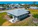 Aerial view of a single-story home with a flat roof and a patio in a waterfront community at 8152 Seashell St, Englewood, FL 34224