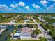 Stunning aerial view of a waterfront home with a private dock and pool, set in a lush, tropical neighborhood at 8152 Seashell St, Englewood, FL 34224