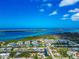 Breathtaking aerial shot of waterfront community, showcasing vibrant blue ocean and lush greenery at 8152 Seashell St, Englewood, FL 34224