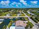 Stunning aerial view of a waterfront home with a private dock and pool, set in a lush, tropical neighborhood at 8152 Seashell St, Englewood, FL 34224