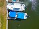An aerial view of two boats, neatly moored and ready for a day out on the shimmering water at 8152 Seashell St, Englewood, FL 34224