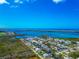 Expansive aerial view showcasing a coastal community with waterways and residential neighborhoods at 8152 Seashell St, Englewood, FL 34224