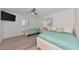 Cozy bedroom showcasing two beds, a ceiling fan, and sleek, modern flooring at 8152 Seashell St, Englewood, FL 34224