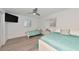Cozy bedroom with two beds, a ceiling fan, and a light-filled ambiance at 8152 Seashell St, Englewood, FL 34224