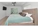 Serene bedroom with soft bedding, ceiling fan, and sliding glass door at 8152 Seashell St, Englewood, FL 34224