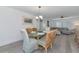 Inviting dining room with a glass table, wicker chairs, and modern chandelier at 8152 Seashell St, Englewood, FL 34224
