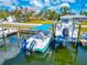 Picturesque waterfront property featuring a private boat dock with two boats and lifts on a sunny day at 8152 Seashell St, Englewood, FL 34224