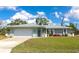 Beautiful home boasting an attached garage, meticulously kept lawn, and a welcoming covered porch at 8152 Seashell St, Englewood, FL 34224