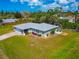 Home exterior displaying lush green lawn and landscaping, paired with a cozy patio and seating area at 8152 Seashell St, Englewood, FL 34224
