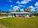 Home exterior boasting well-maintained landscaping and a spacious lawn at 8152 Seashell St, Englewood, FL 34224