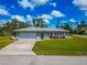 Inviting single-story home featuring a two-car garage, fresh landscaping, and a serene setting at 8152 Seashell St, Englewood, FL 34224