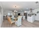 Open living area with dining and kitchen featuring natural light and wood-look floors throughout at 8152 Seashell St, Englewood, FL 34224