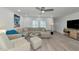 Bright living room featuring modern furniture, a ceiling fan, and recessed lighting at 8152 Seashell St, Englewood, FL 34224